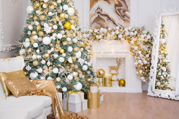 istock Interior of luxury interior with fireplace, comfortable sofa and chandelier decorated with Christmas tree and gifts 1443000475