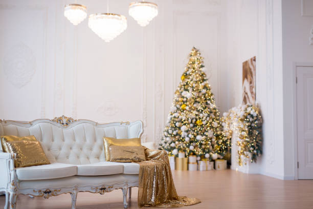 istock Interior of luxury interior with fireplace, comfortable sofa and chandelier decorated with Christmas tree and gifts 1443000554