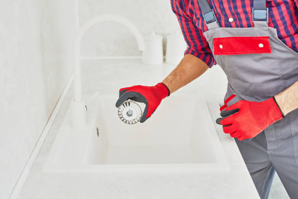 istock Plumber installing sink in kitchen. Worker installs a sink filter or plug. 1443000956