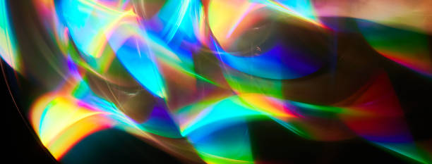 istock Blurred bright rainbow light. Lens or prism dynamic flare. Draving shiny spots. Dark background. Illuminated burst of multicolor light. 1443000962