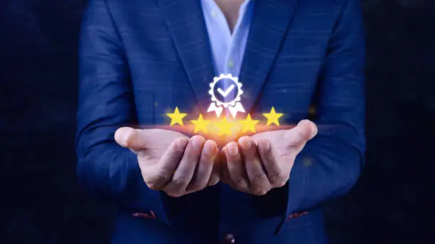 Photo of Businessman hand shows the sign of the top service Quality assurance 5 star, Guarantee, best product, Standards, ISO certification and standardization concept.