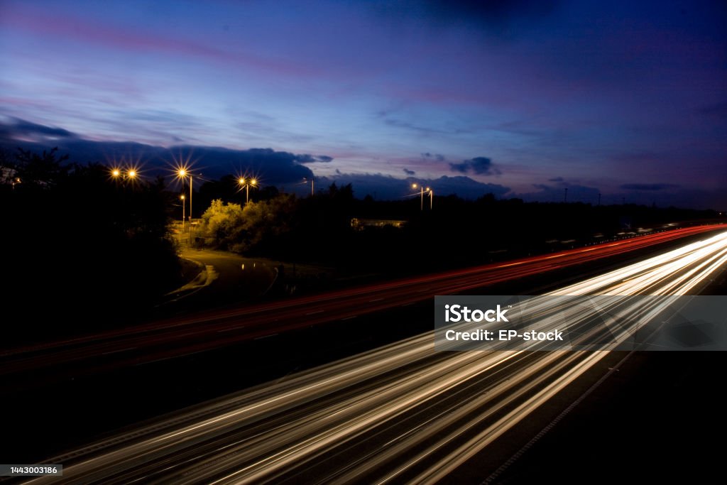 Fast moving traffic on M6 Motorway at Night National Highways Doxey Depot Traffic Stock Photo
