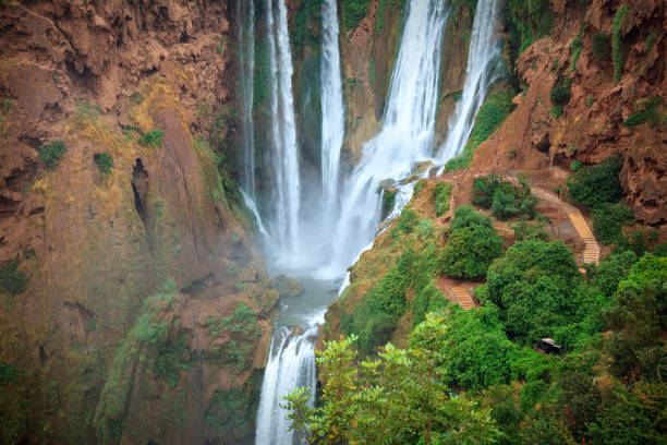 Ouzoud Falls is the collective name for several waterfalls that empty into the El-Abid River's gorge. This popular tourism destination is located near the Middle Atlas village of Tanaghmeilt, in the province of Azilal, 150 km northeast of Marrakech, Morocco. 'Ouzoud' means \