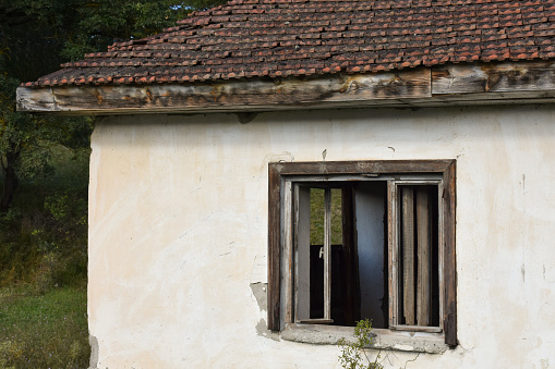 Wooden parts like windows, doors, roof and walls on an old house with a garden