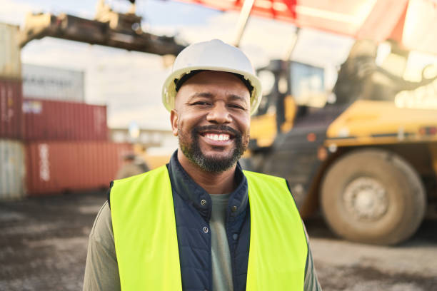 istock Portrait, smile and work in logistics with container at export and distribution shipyard. Black man, happy and confident has motivation working in shipping, cargo and supply chain industry at port 1443006682