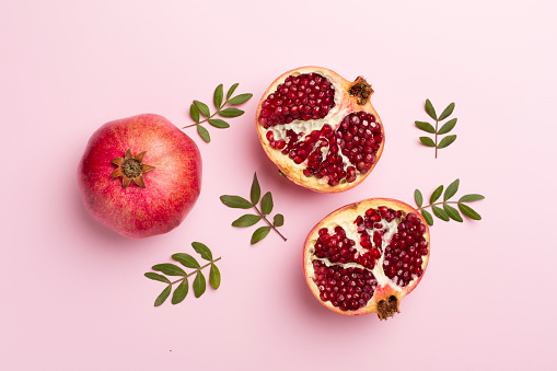 Pomegranate Fruits cut open with seeds on dark background