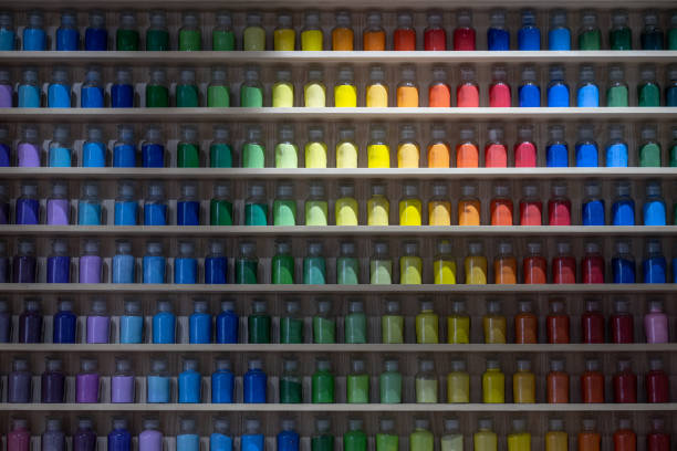Colorful paint bottles on wooden shelves