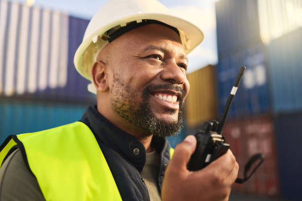 istock Logistics, supply chain and radio with a man delivery professional working on a dock or container yard. Communication, shipping and cargo with a male courier at work in distribution, stock or export 1443009700