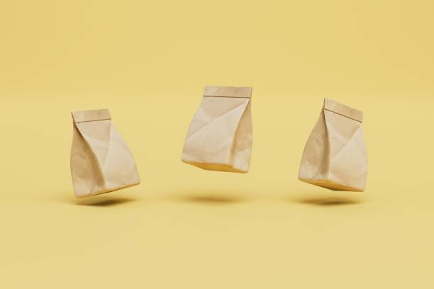 paper packing bags for fast food delivery on a yellow background. 3d render - paper bag bag packed lunch paper imagens e fotografias de stock