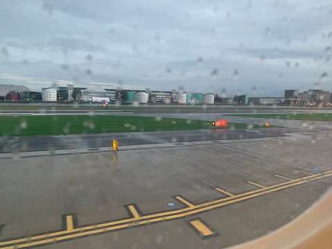 View out of the airplane window at very wet LCY airport