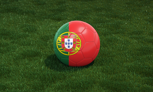 Soccer ball with Portugal flag colors at a stadium on green grasses background. 3D illustration.