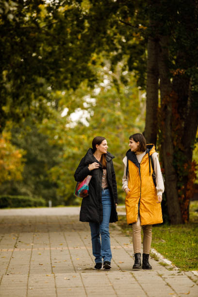 istock Two young women taking a relaxing walk through the park, chatting casually and bonding 1443020055