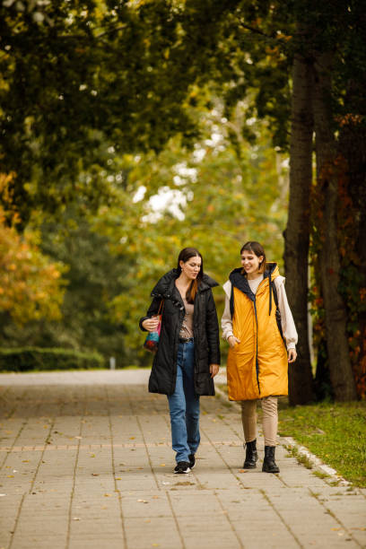 istock Two young women taking a relaxing walk through the park, chatting casually and bonding 1443020095