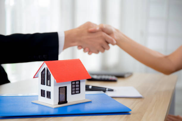 Closeup hands of real estate agent and customer handshake together after agreement together about credit house and insurance, client and consulting of investment about residential, business concept. stock photo