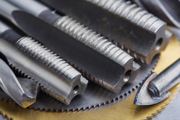 istock set of different drill bits,thread tap and mill cutters with caliper ruler on steel plate background. Locksmithing deal. 1443023079