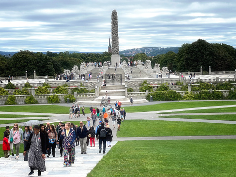 August 28, 2022 - Oslo, Norway.  Visitors to the city enjoy walking through the sculpture park which is Gustav Vigeland's life work, comprising over 200 sculptures in granite, bronze and wrought iron.