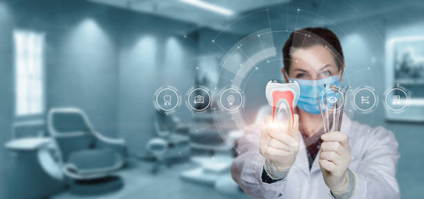 Dentist shows tooth icons . Dentist shows tooth icons on virtual computer screen. educational subject stock pictures, royalty-free photos & images