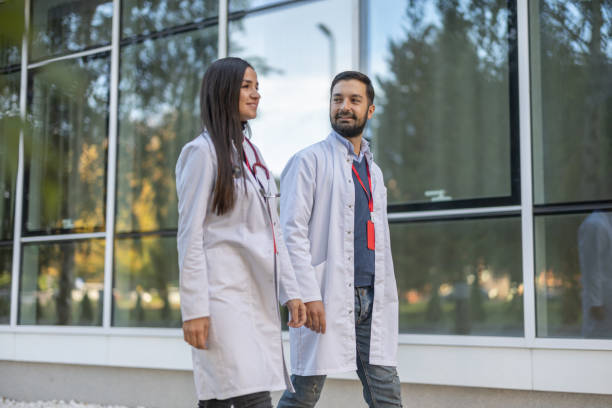 istock Two doctors walking by the hospital 1443026372