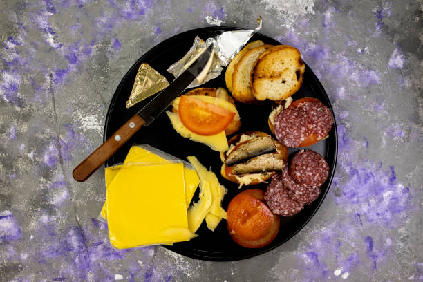 istock Snack sandwiches on a round plate, top view, on an abstract concrete background 1443027781
