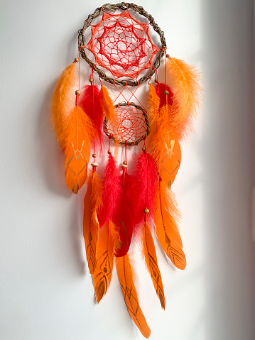 Close-up red orange dreamcatcher details tribal bohemian craft wall hanging home decor