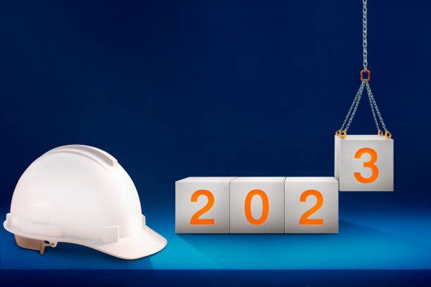 istock engineer working table and lifting concrete cubes by crane construction for preparation of welcome 2023, new year party, and change new business. 1443031837