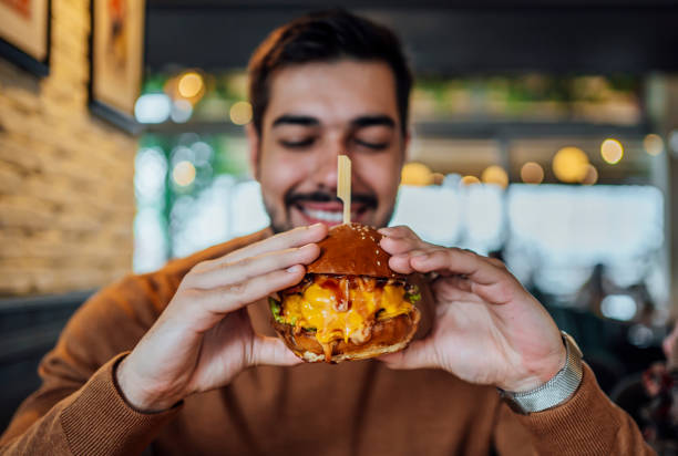 istock Young man ready to eat a burger 1443032066