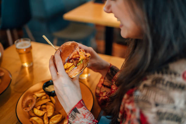 istock Young woman ready to eat a burger 1443032287