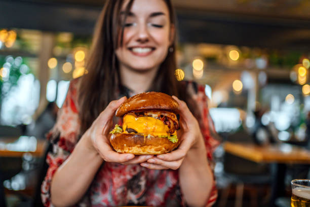 istock Young woman ready to eat a burger 1443032385