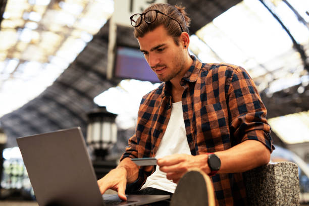 Young man buying online with credit card. stock photo