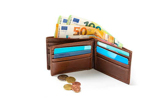 concept of inflation, rising consumer prices. Brown leather wallet and European currency