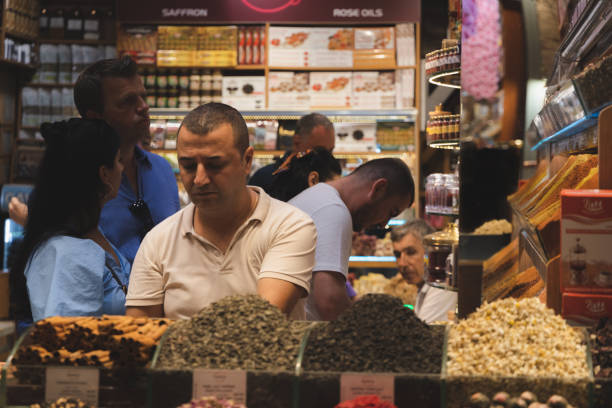 Spice Bazaar, Istanbul Istanbul, Turkey - October 1 2022: Shoppers and vendors at a colourful shop display of spices at the Spice Bazaar in Istanbul, Turkey. tivoli bazaar stock pictures, royalty-free photos & images