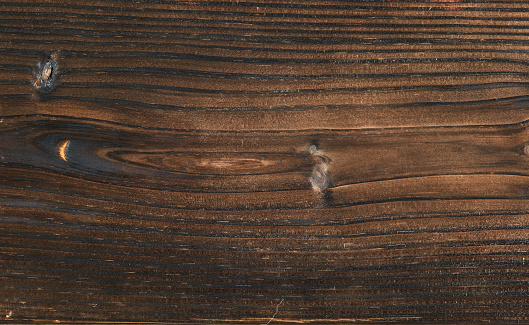 Close up of rough old striped wood texture with rusted nails. Detail of old door. Horizontal seamless pattern with vertical lines in the wood structure. Brown grey natural colored wood. Used for walls, floors and natural backgrounds.