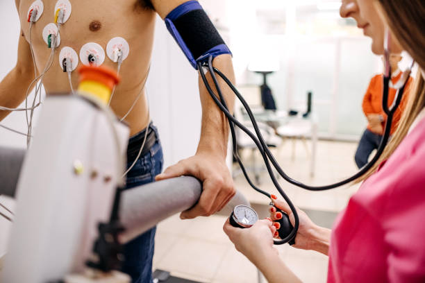 Cardiac stress test Male patient pedaling on a treadmill ergometer stress test system for checking heart function checking sports stock pictures, royalty-free photos & images