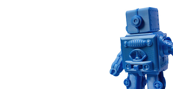 A blue 3d-printed plastic toy robot isolated against a wide pure white background