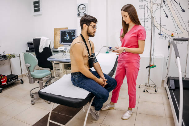 istock Doctor puts a holter on a man's chest 1443049161