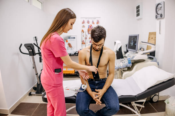 istock Doctor puts a holter on a man's chest 1443049212