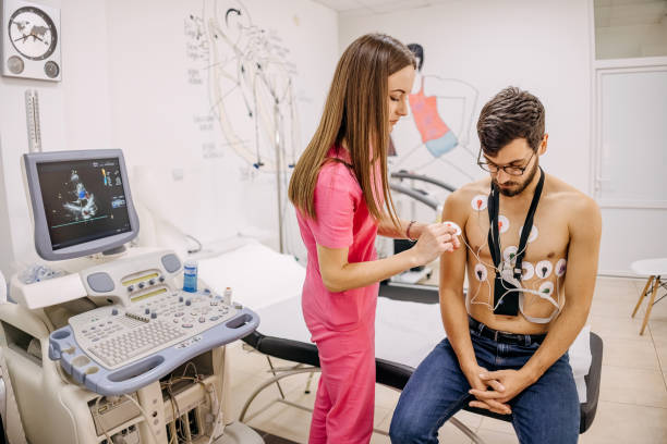 istock Doctor puts a holter on a man's chest 1443049800