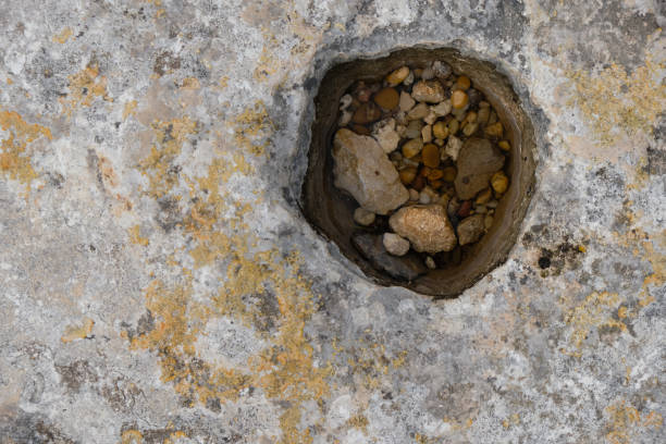 Clean rainwater is in a stone pit. Copy space. Les Baux-de-Provence, France.