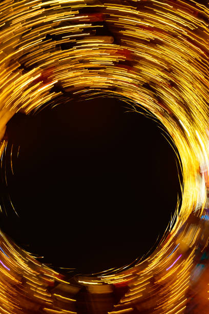 Abstract round texture of golden neon lights in motion with black empty copy space. High quality photo