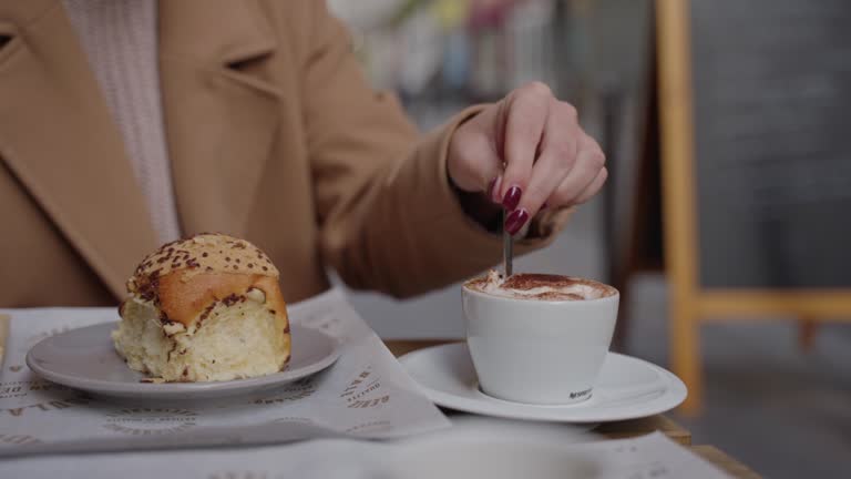 B-roll of woman mixing cappuccino