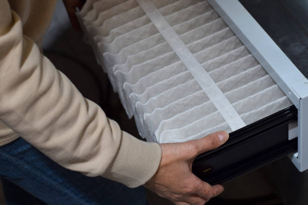 istock Closeup woman's hands replacing furnace filter at home 1443052131