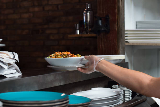 istock Restaurant kitchen employee placing food order for server to pick up 1443053665