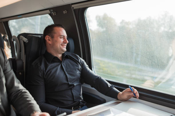 istock Business man smiling when riding on a train 1443053897