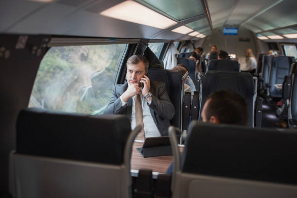 istock Business man sitting on a train and having a phone conversation 1443053934
