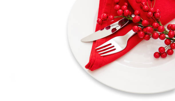 istock Holiday table setting. Silver Cutlery and red cloth napkin on white plate, close up 1443056657