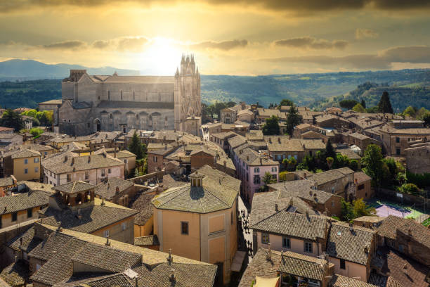 Orvieto historical Old town, Italy Orvieto historical Old town, view over roofs to the Duomo Cathedral in dramatical sunset light orvieto stock pictures, royalty-free photos & images