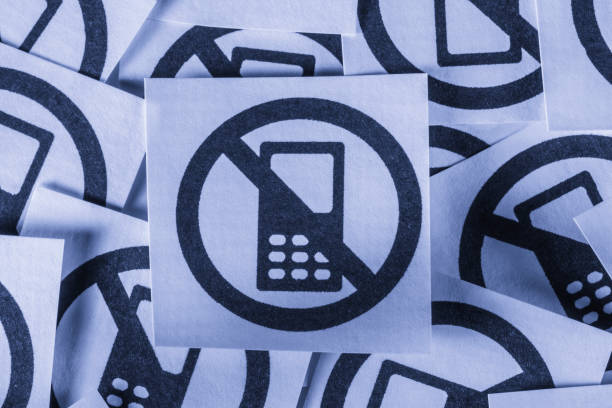Symbols of prohibited mobile phones written on paper