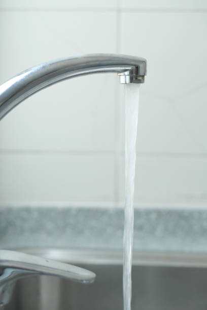 istock water pouring from a faucet tap slow motion 1443057666