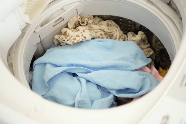 istock close up of cloths in a washing machine. 1443057672