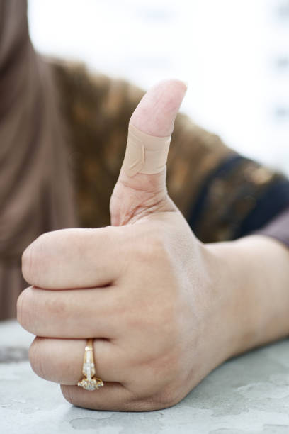 istock adhesive bandage on hand close up 1443057680